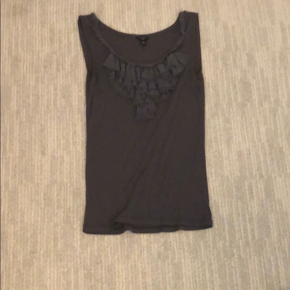 a top with ruffles on the middle